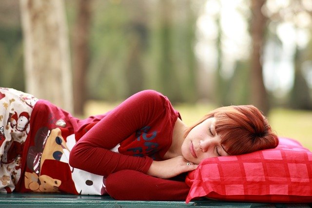 Young woman sleeping on a red pillow